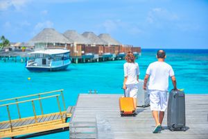 People carrying bags at the beach
